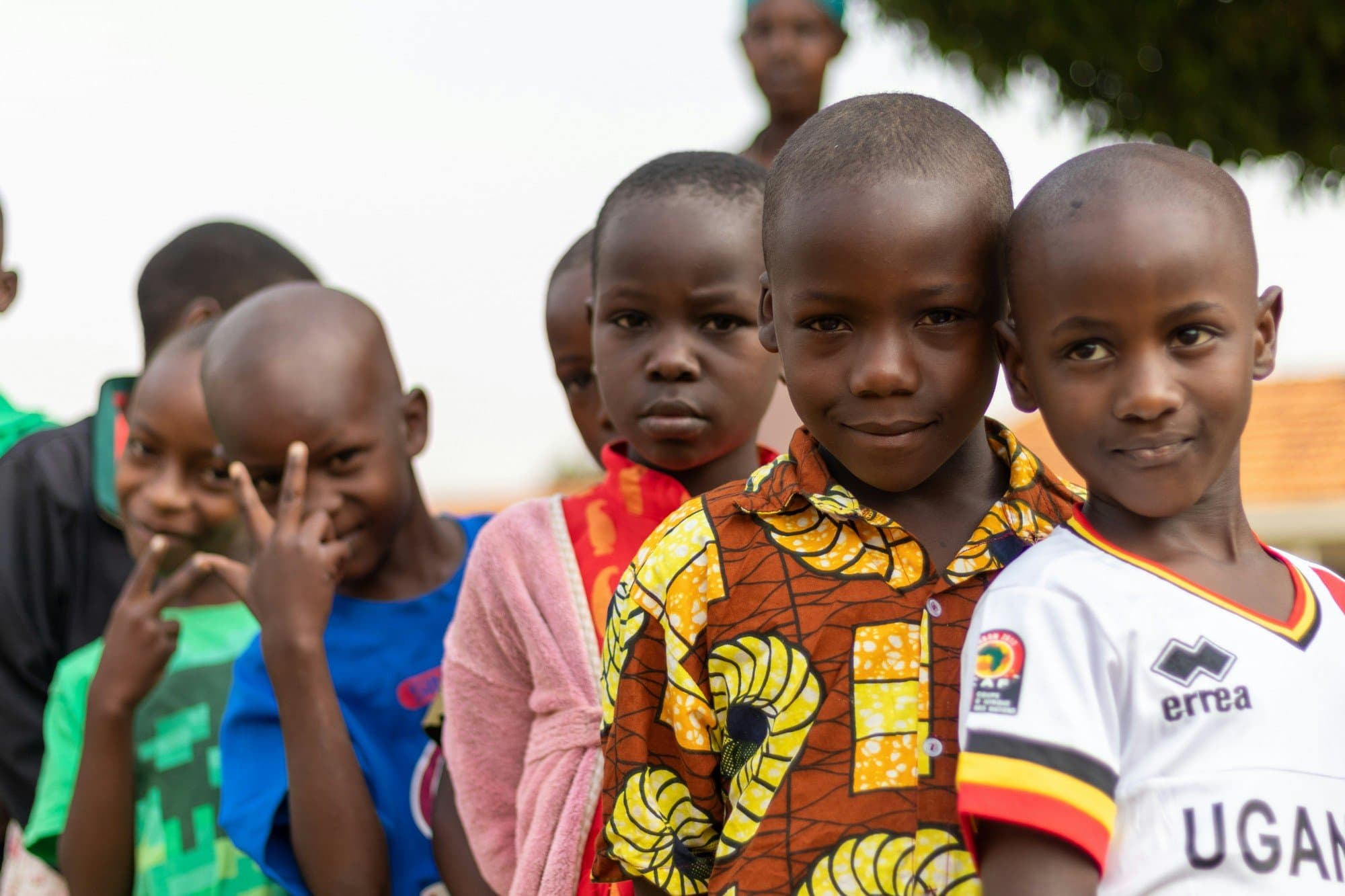 Young children in a Kupanda Collective community, smiling and playing together